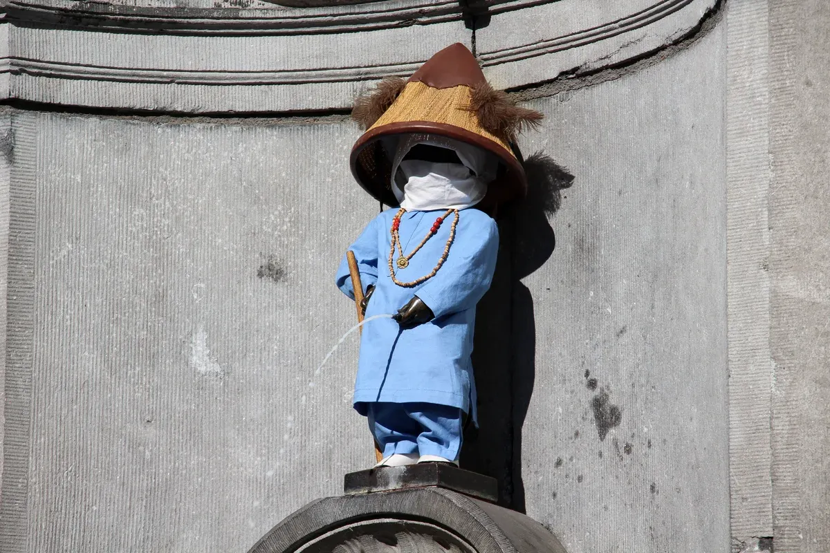 Manneken Pis dressed in costume near the Choco-Story museum, a stop on chocolate tours in Brussels